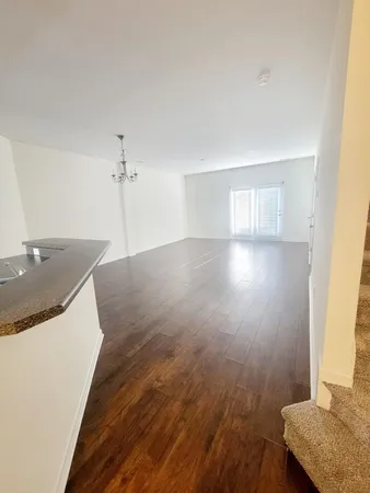 a view of a kitchen with sink and wooden floor