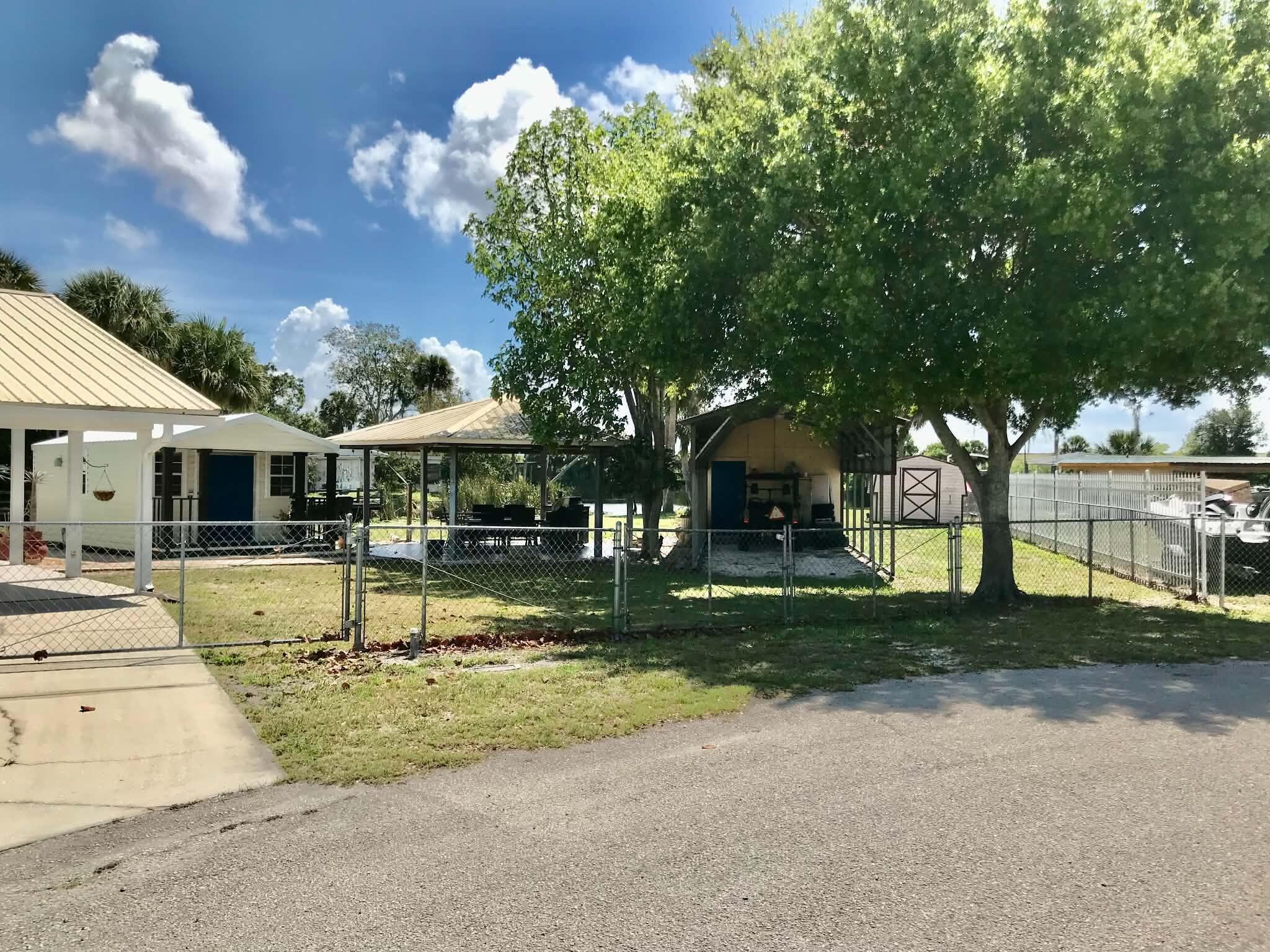 1115 Elm Street Okeechobee, FL 34974 - Photo 31 of 37 a view of a house with backyard and sitting area