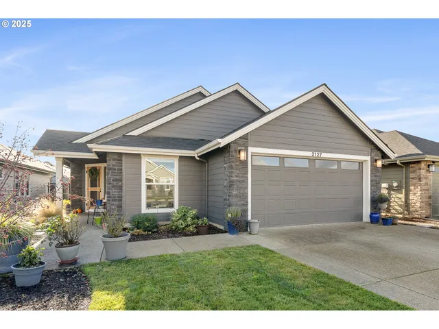 a front view of house with a garden