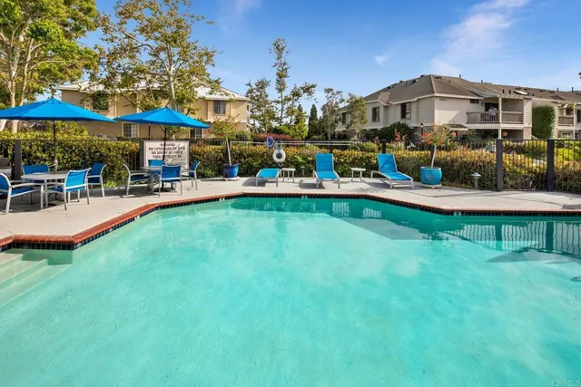 a view of a house with swimming pool and sitting area