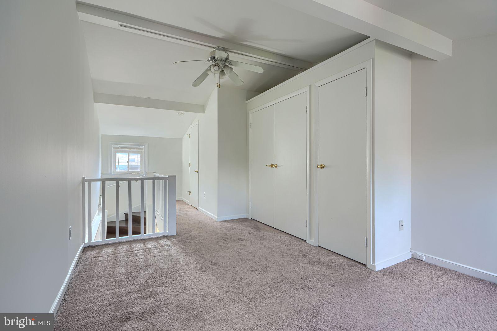 1026 Patapsco Street Baltimore, MD 21230 - Photo 19 of 24 an empty room with chandelier fan and windows