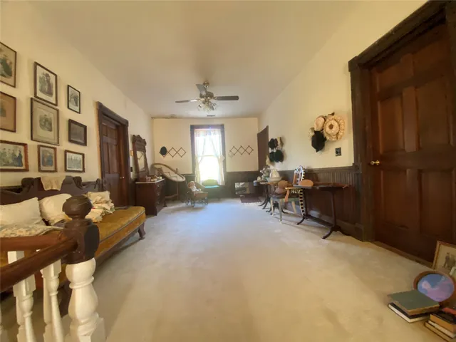 a view of a white house next to a yard