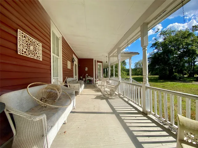 a view of a a dining room with furniture window and wooden floor