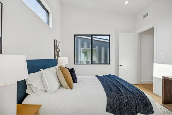 a bedroom with a bed and a window