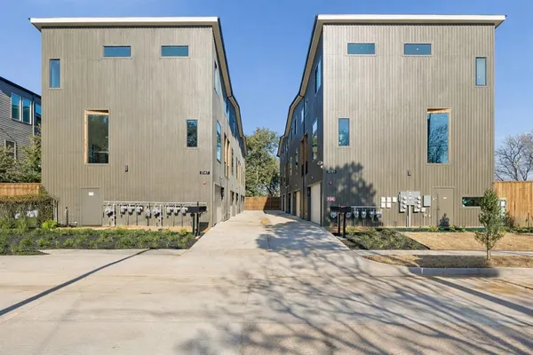 a bathroom with double vanity and a mirror