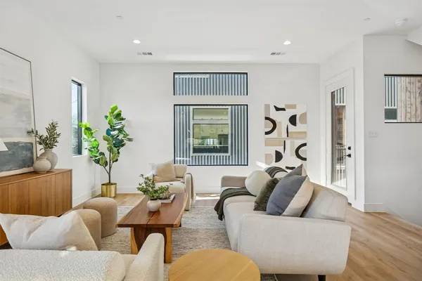 a living room with furniture and a potted plant