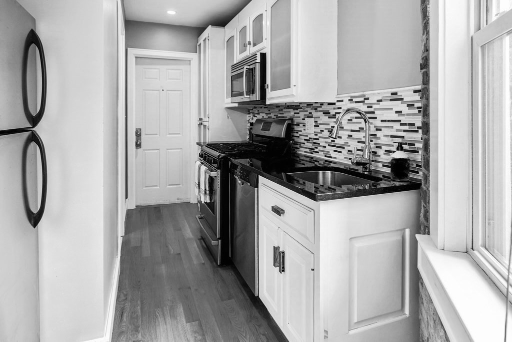 1 Unity Street, Unit 4R Boston, MA 02113 - Photo 4 of 13 a kitchen with a sink and a stove top oven
