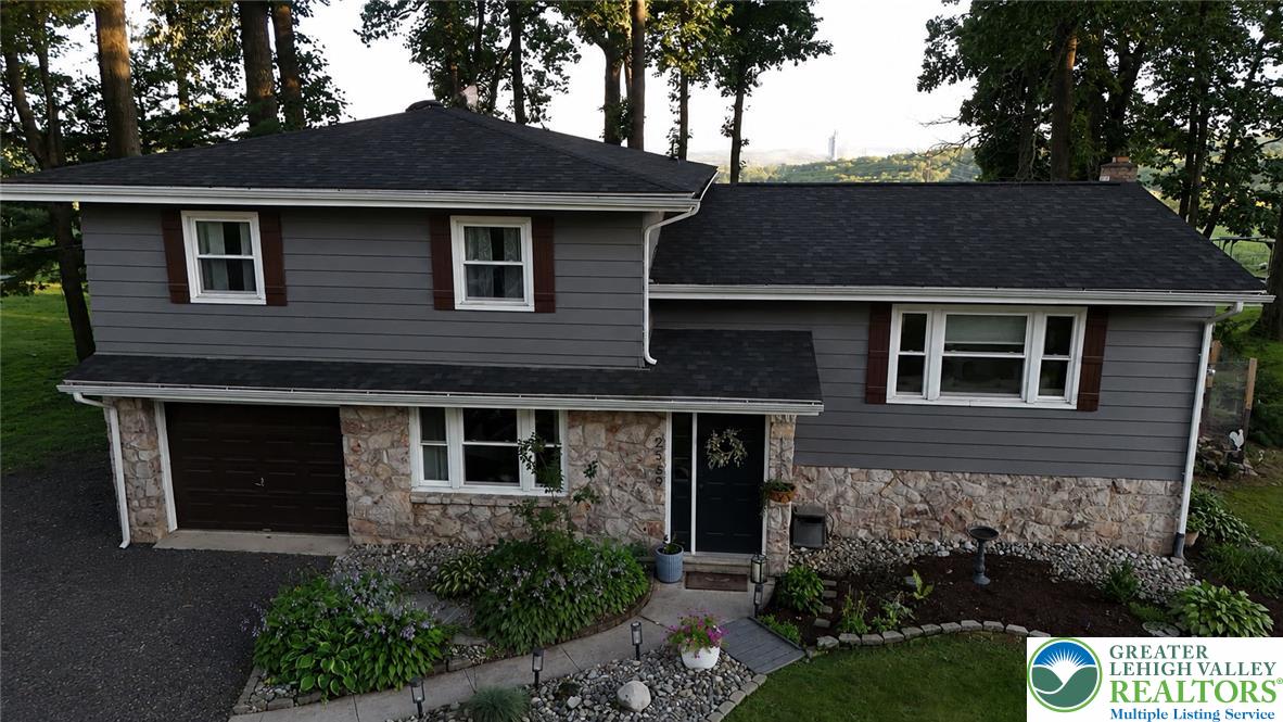 2569 Woods Edge Road Bath, PA 18014 - Photo 24 of 40 Textured stone veneer accents the lower level of this traditional multi-level home.