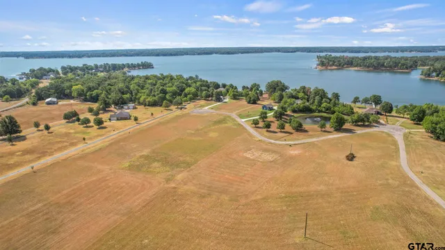 an aerial view of a house with a lake view