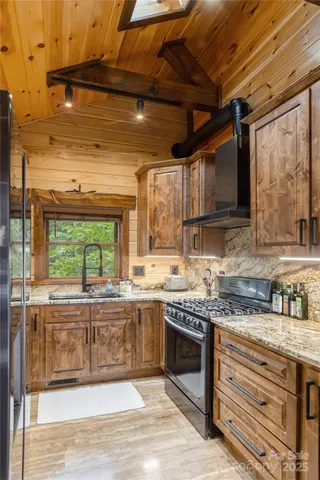 a kitchen with stainless steel appliances granite countertop wooden cabinets and a counter top