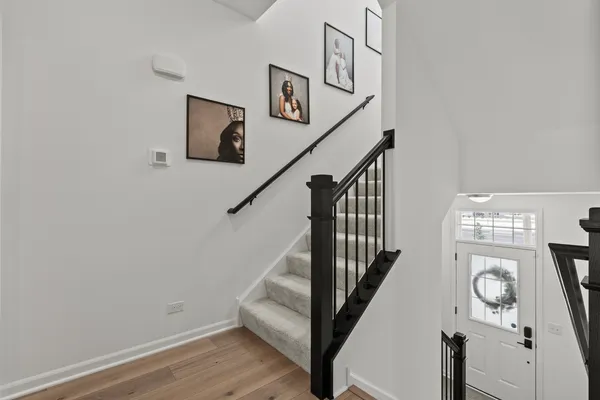 a view of entryway and hall with wooden floor
