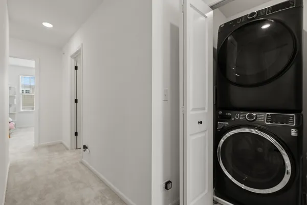 a view of a hallway with washer and dryer