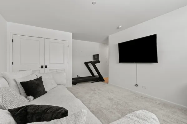 a bedroom with a bed a flat screen tv and wall