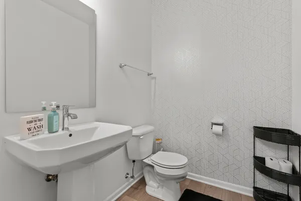 a bathroom with a sink a toilet and a mirror