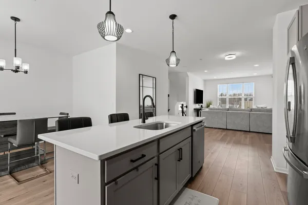 a kitchen with sink cabinets and wooden floor