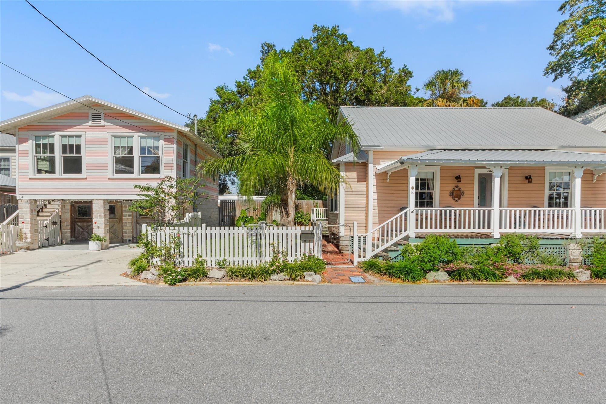 16 Locust Street St. Augustine, FL 32084 - Photo 28 of 76 View of front facade with covered porch, a carport, concrete driveway, and a metal roof