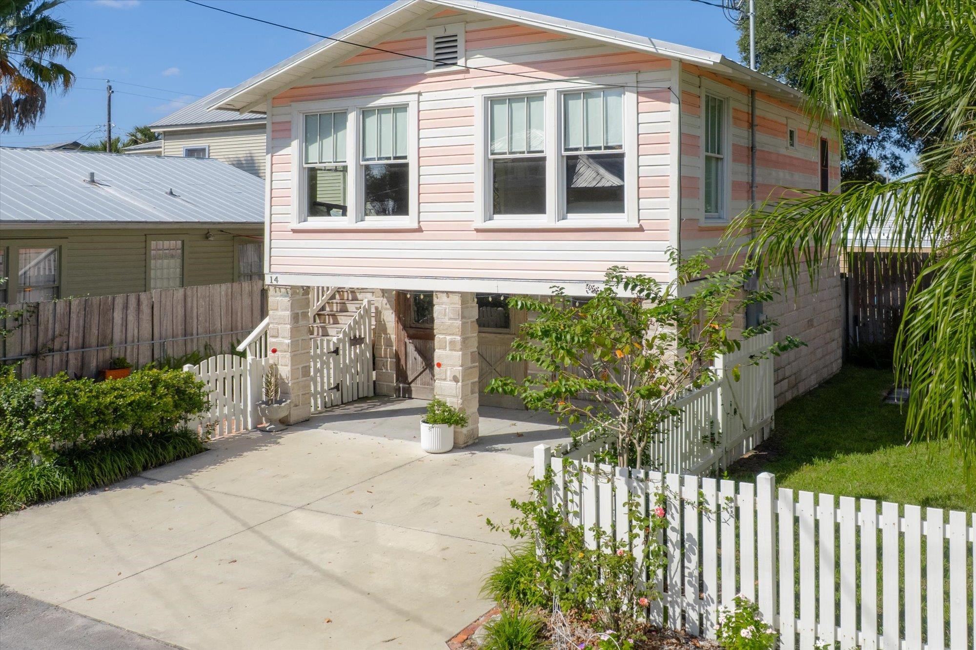 16 Locust Street St. Augustine, FL 32084 - Photo 44 of 75 a front view of a house with a garden