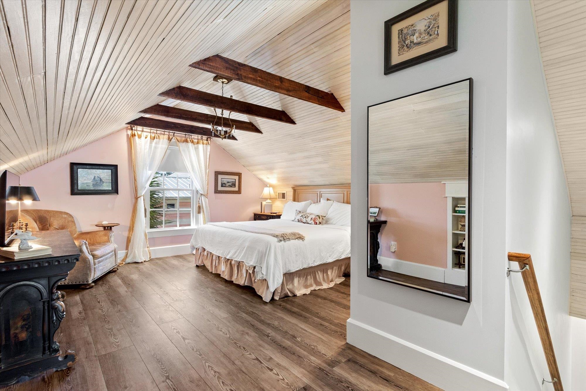 16 Locust Street St. Augustine, FL 32084 - Photo 44 of 76 Bedroom featuring dark wood-style floors, wooden ceiling, and a wood stove