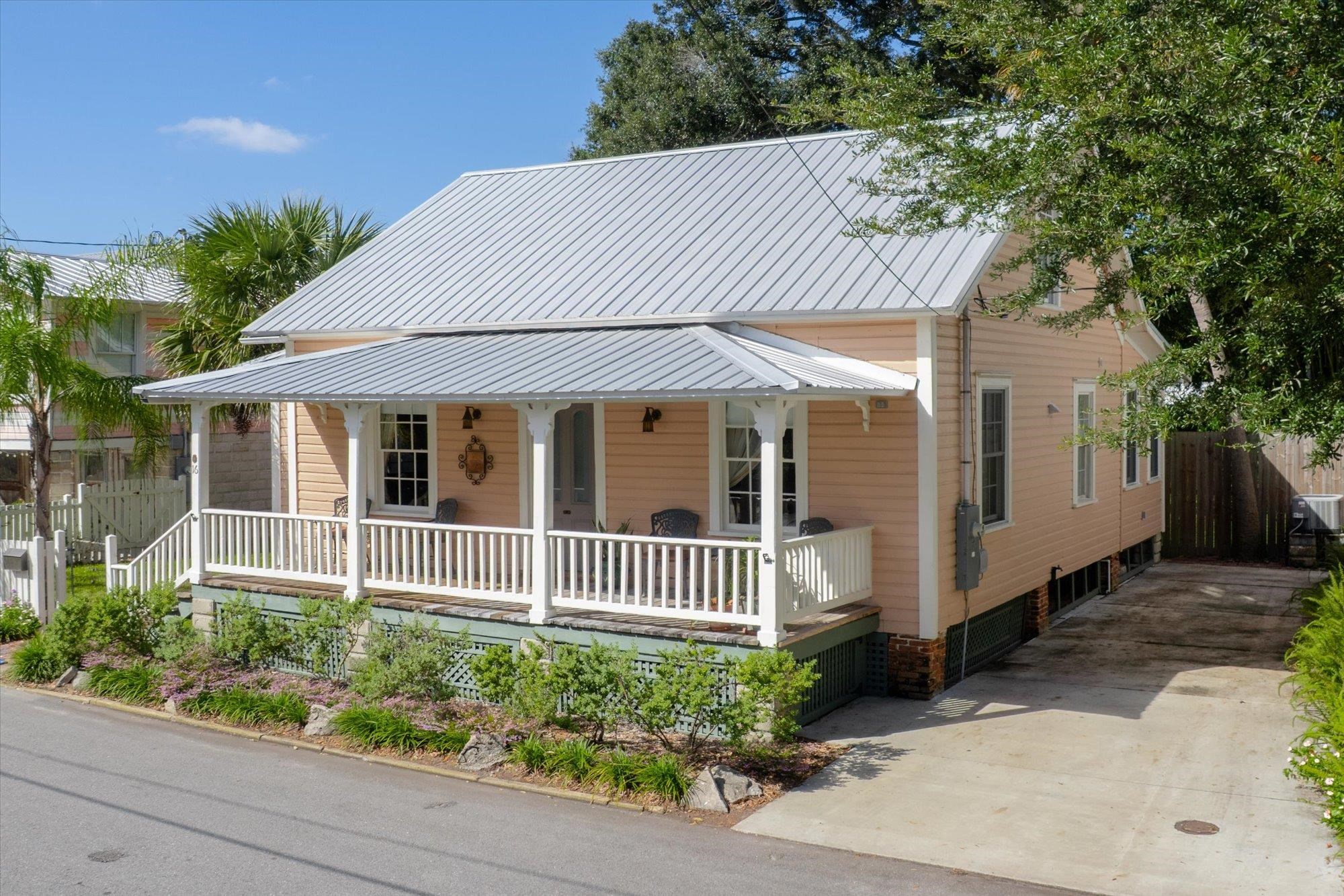 16 Locust Street St. Augustine, FL 32084 - Photo 47 of 75 View of front facade featuring covered porch, a metal roof, and concrete driveway