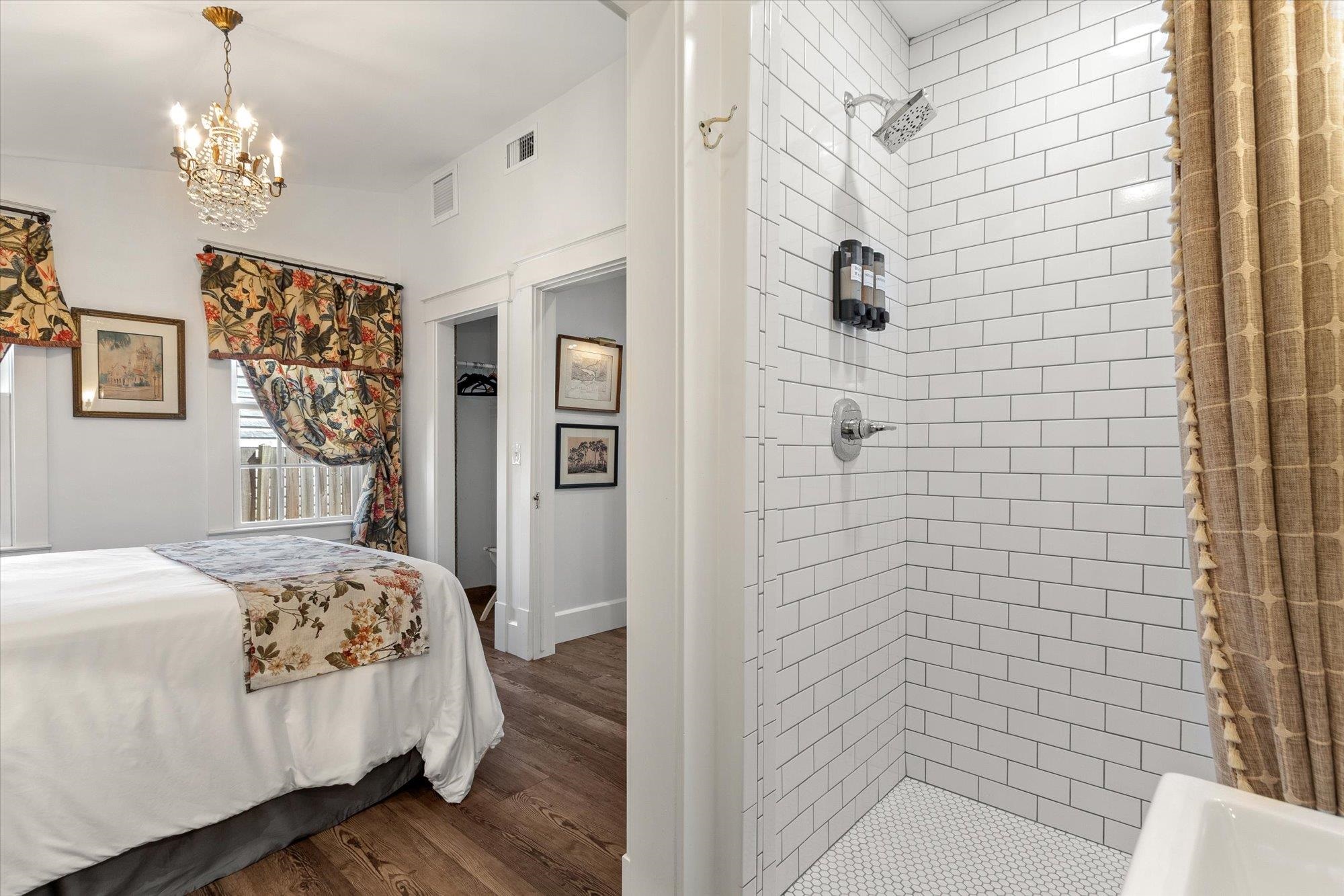 16 Locust Street St. Augustine, FL 32084 - Photo 51 of 76 Bedroom featuring dark wood-type flooring and a chandelier