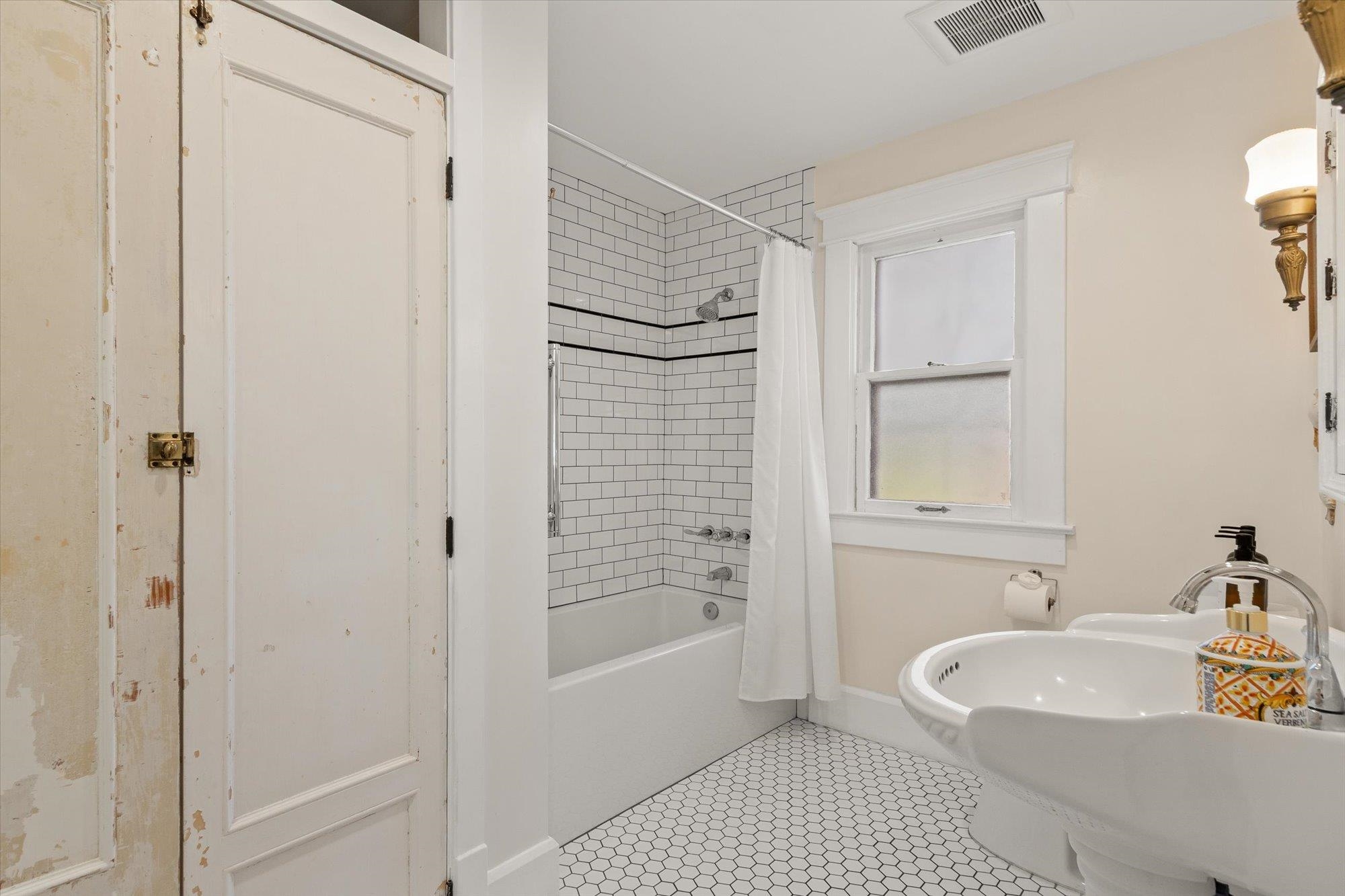 16 Locust Street St. Augustine, FL 32084 - Photo 57 of 75 a bathroom with a sink a mirror and a bathtub