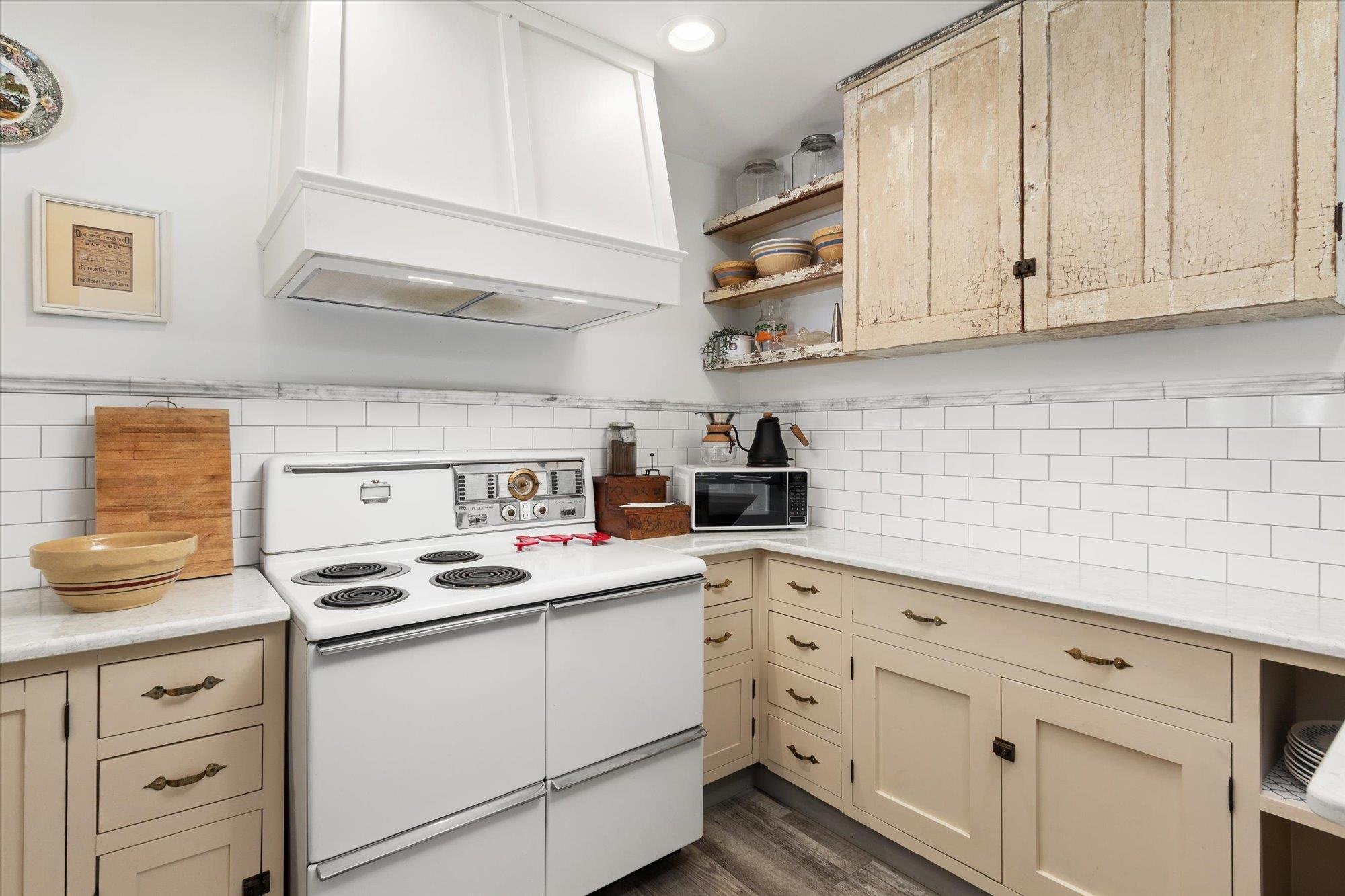 16 Locust Street St. Augustine, FL 32084 - Photo 60 of 76 Kitchen featuring open shelves, double oven range, cream cabinets, custom range hood, and dark wood-style floors