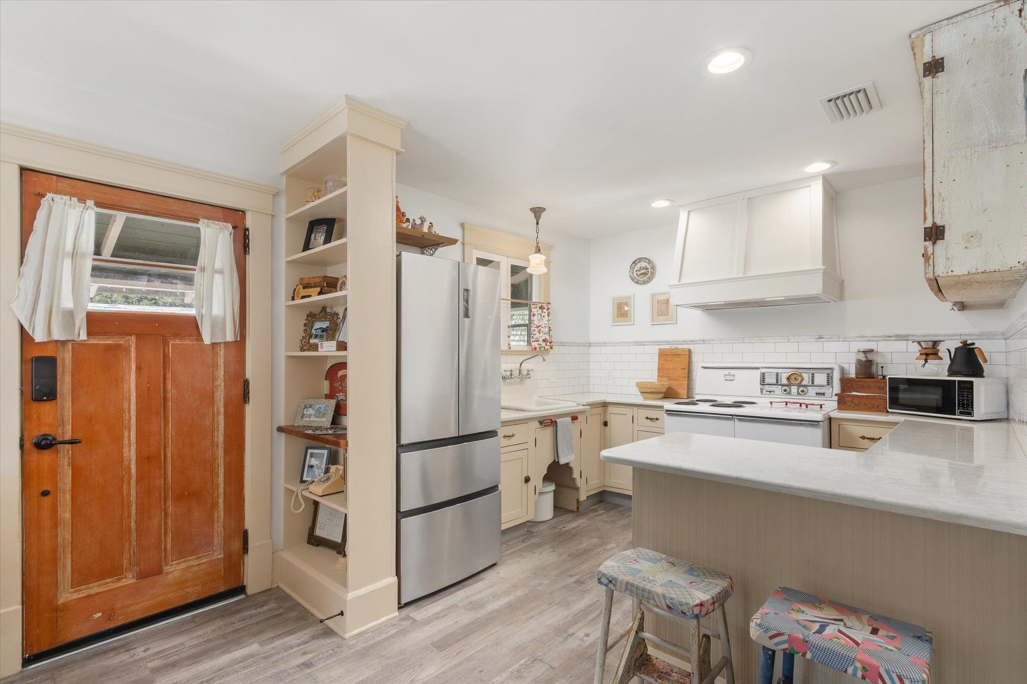 16 Locust Street St. Augustine, FL 32084 - Photo 61 of 75 a kitchen with stainless steel appliances granite countertop a refrigerator and a stove top oven