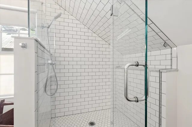 a kitchen with stainless steel appliances granite countertop a stove and white cabinets