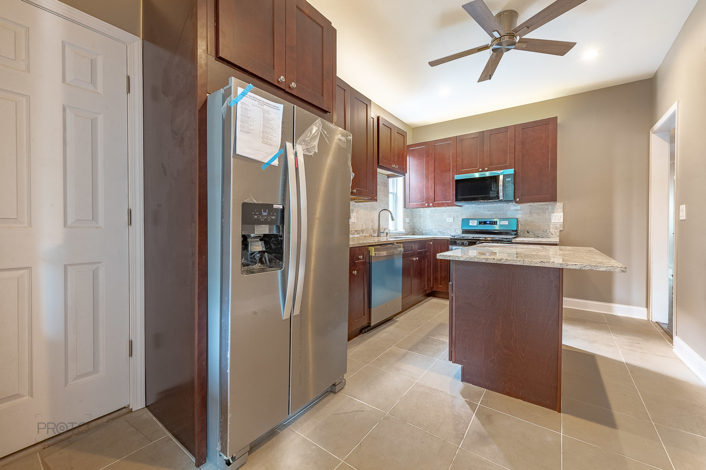 35 North Mayfield Avenue, Unit 1 Chicago, IL 60644 - Photo 9 of 15 a kitchen with stainless steel appliances granite countertop a refrigerator a sink a stove a microwave oven with cabinets