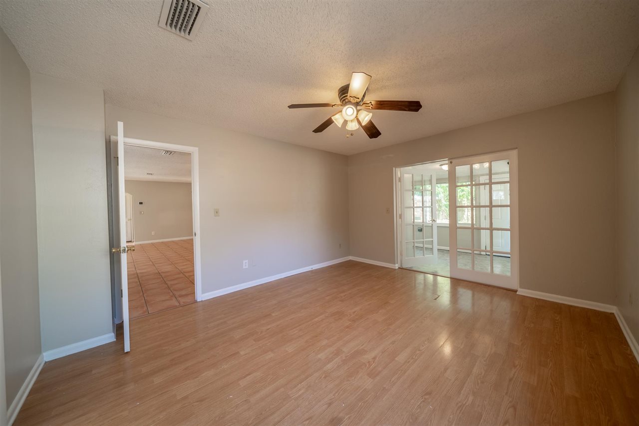 626 Segovia Road St. Augustine, FL 32086 - Photo 13 of 30 wooden floor in an empty room with a window
