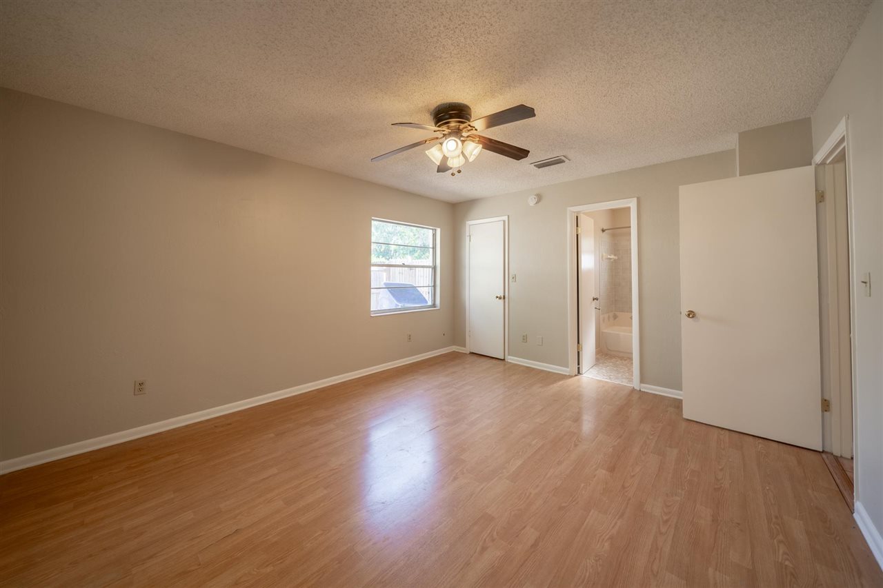 626 Segovia Road St. Augustine, FL 32086 - Photo 15 of 30 a view of an empty room with a window and wooden floor