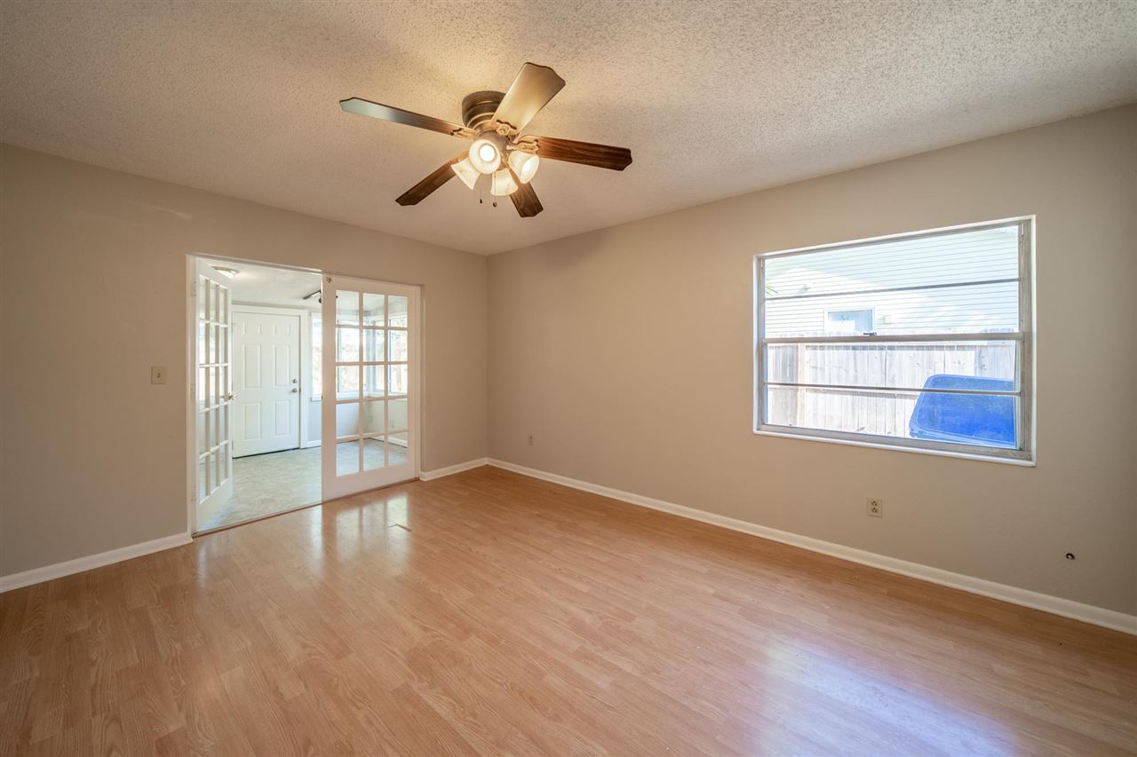 626 Segovia Road St. Augustine, FL 32086 - Photo 17 of 30 a view of an empty room with wooden floor and a window