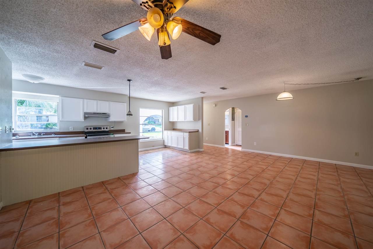 626 Segovia Road St. Augustine, FL 32086 - Photo 28 of 30 a kitchen with stainless steel appliances granite countertop a refrigerator and a stove top oven