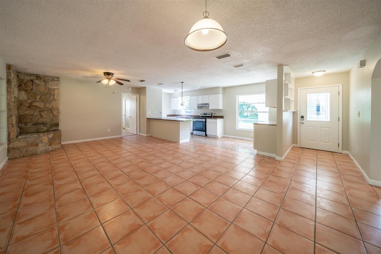 626 Segovia Road St. Augustine, FL 32086 - Photo 4 of 30 a view of a kitchen with kitchen island white cabinets and refrigerator