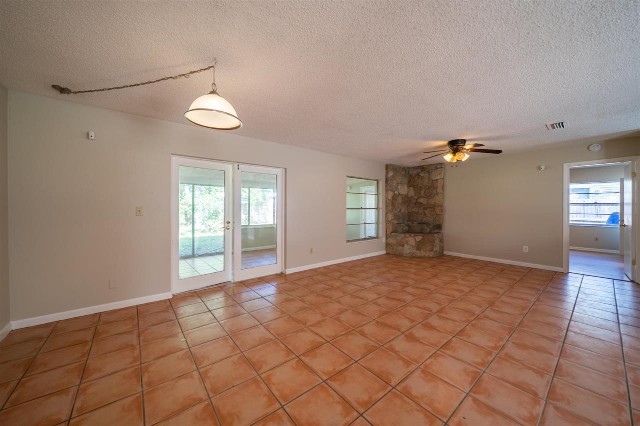 626 Segovia Road St. Augustine, FL 32086 - Photo 5 of 30 a view of an empty room with window and chandelier fan