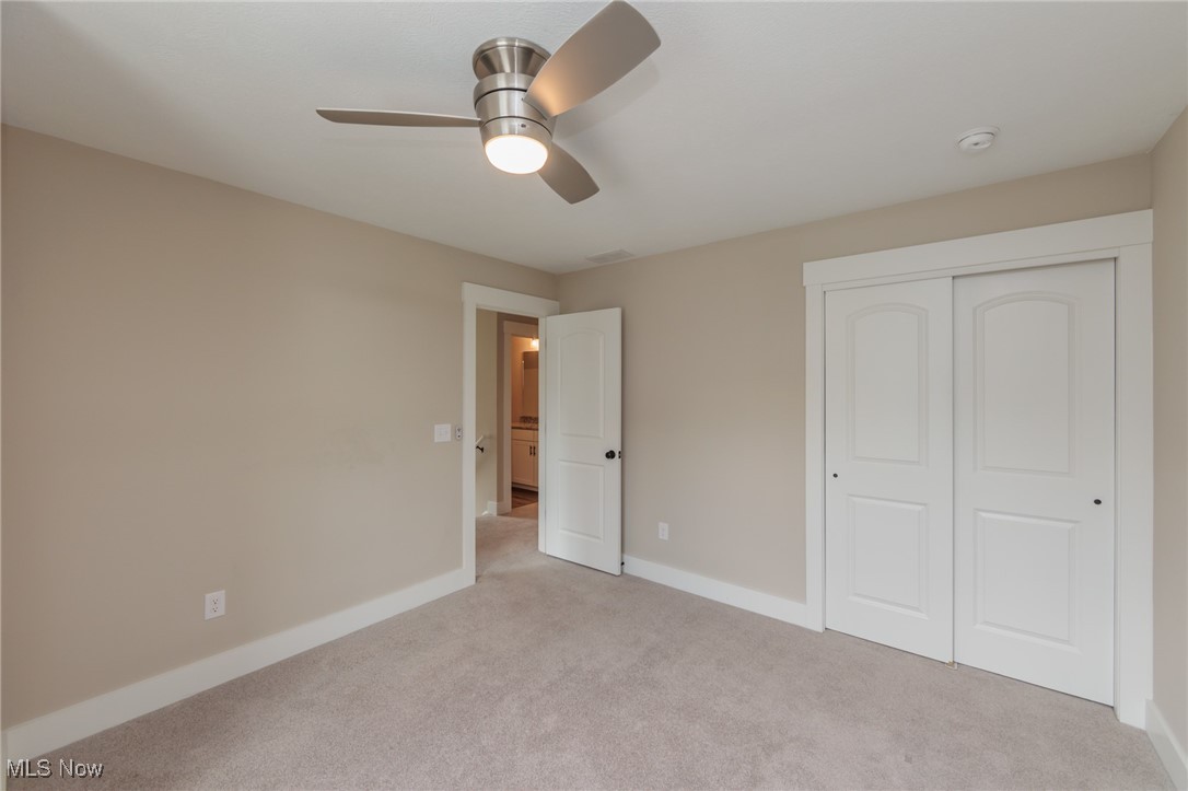36458 Appian Way North Ridgeville, OH 44039 - Photo 23 of 37 Unfurnished bedroom with light colored carpet, ceiling fan, and a closet
