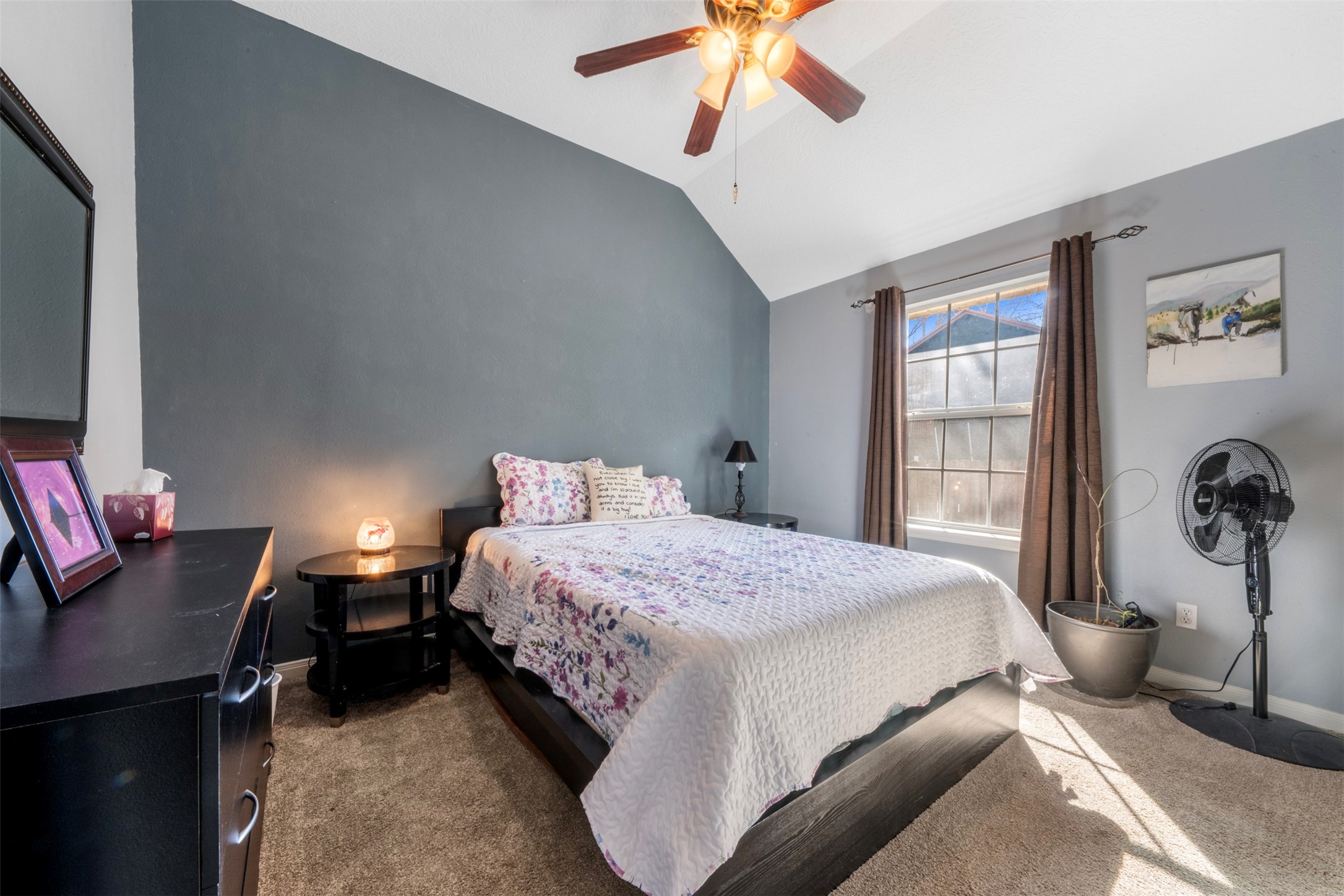 411 Shawnee Conroe, TX 77316 - Photo 12 of 30 a bedroom with a bed and a chandelier