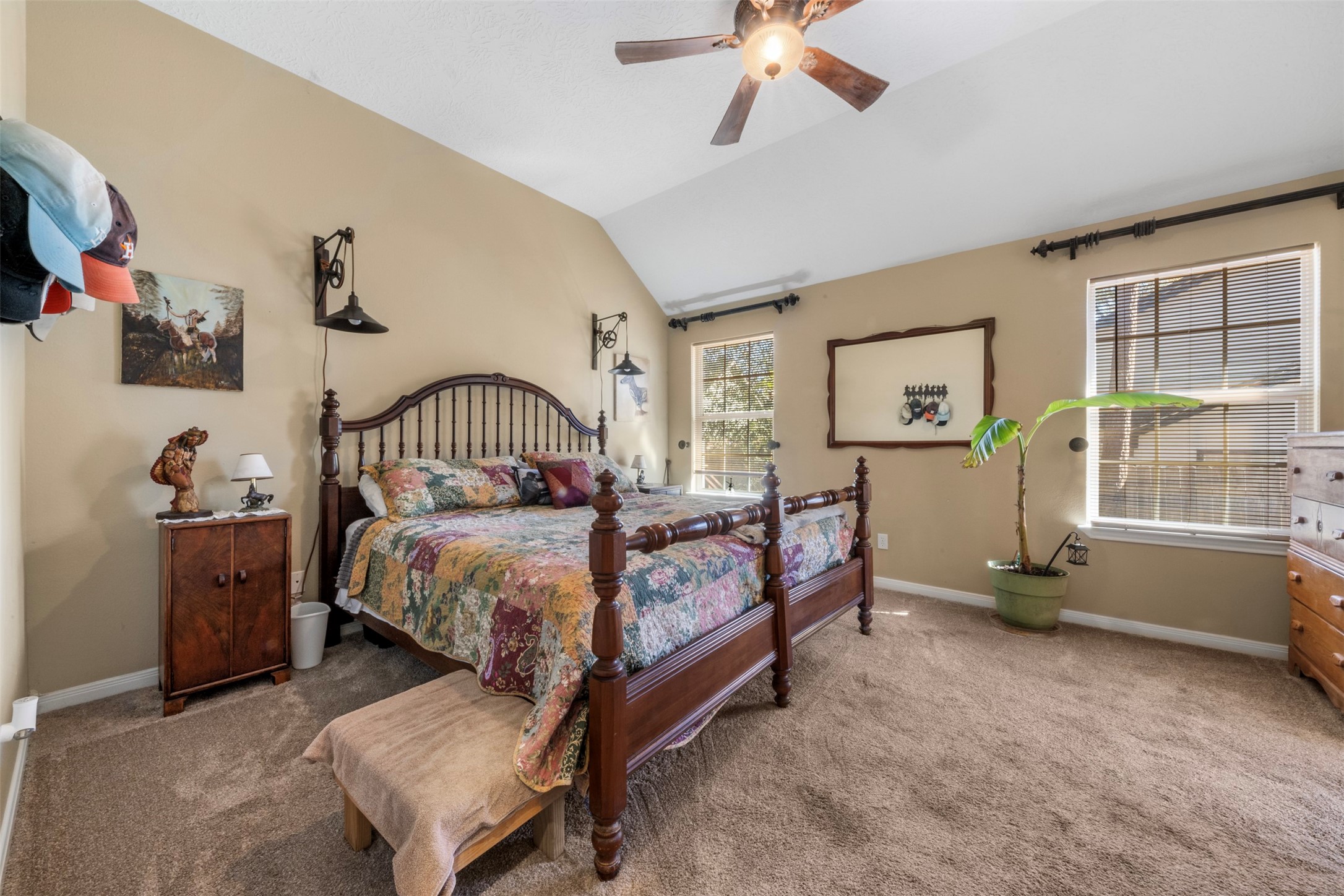 411 Shawnee Conroe, TX 77316 - Photo 15 of 30 a bedroom with a bed and a chandelier