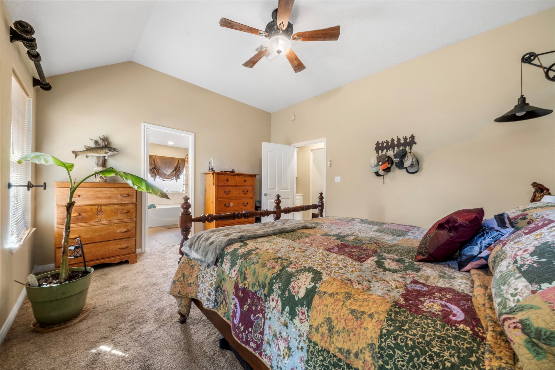 411 Shawnee Conroe, TX 77316 - Photo 16 of 30 a bedroom with a bed and a chandelier