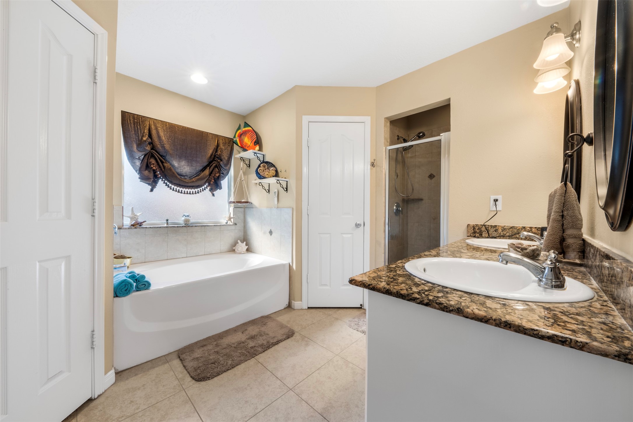 411 Shawnee Conroe, TX 77316 - Photo 17 of 30 a bathroom with a granite countertop sink and a mirror