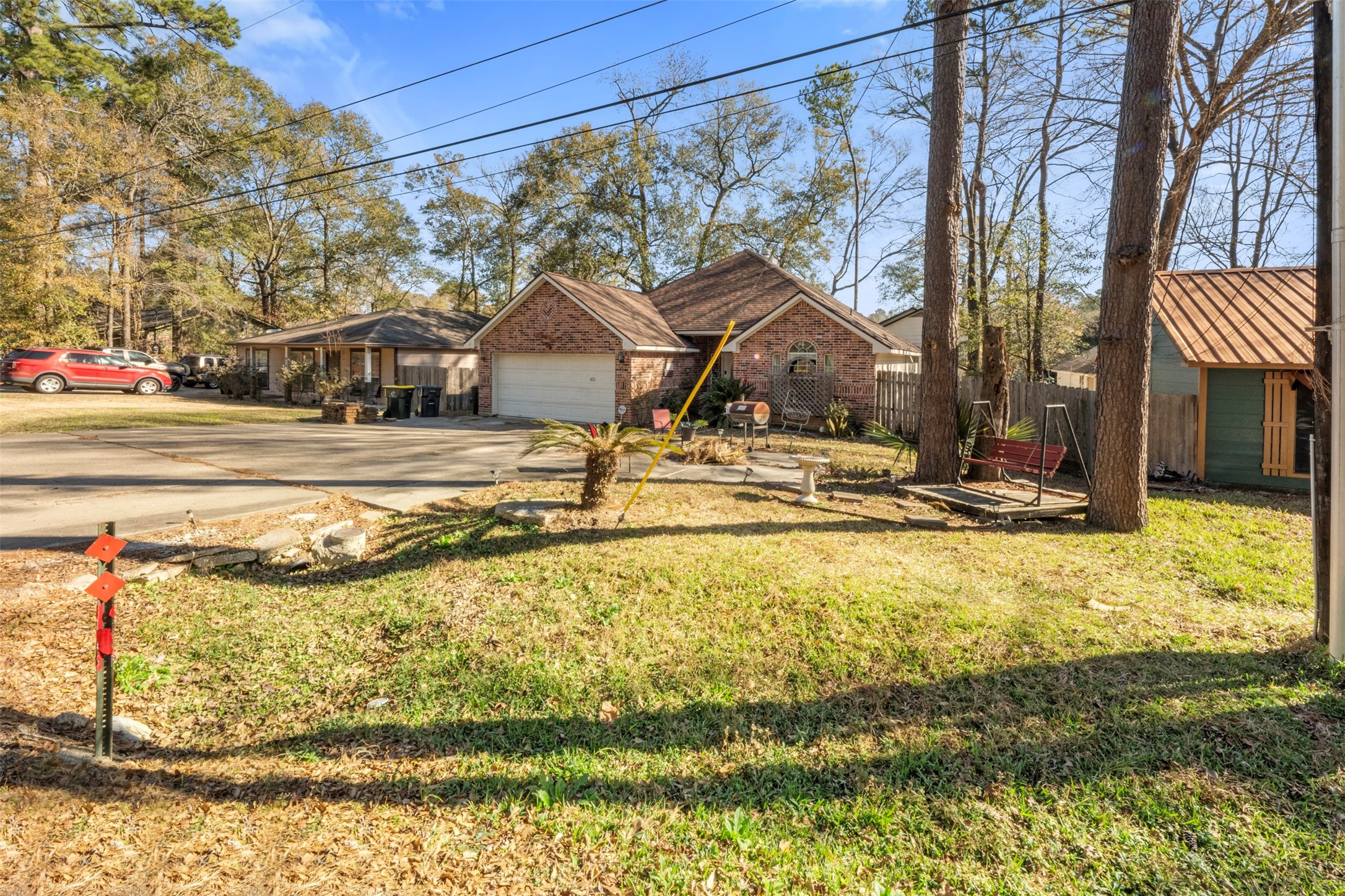 411 Shawnee Conroe, TX 77316 - Photo 2 of 30 a view of swimming pool with a lawn chairs under an umbrella