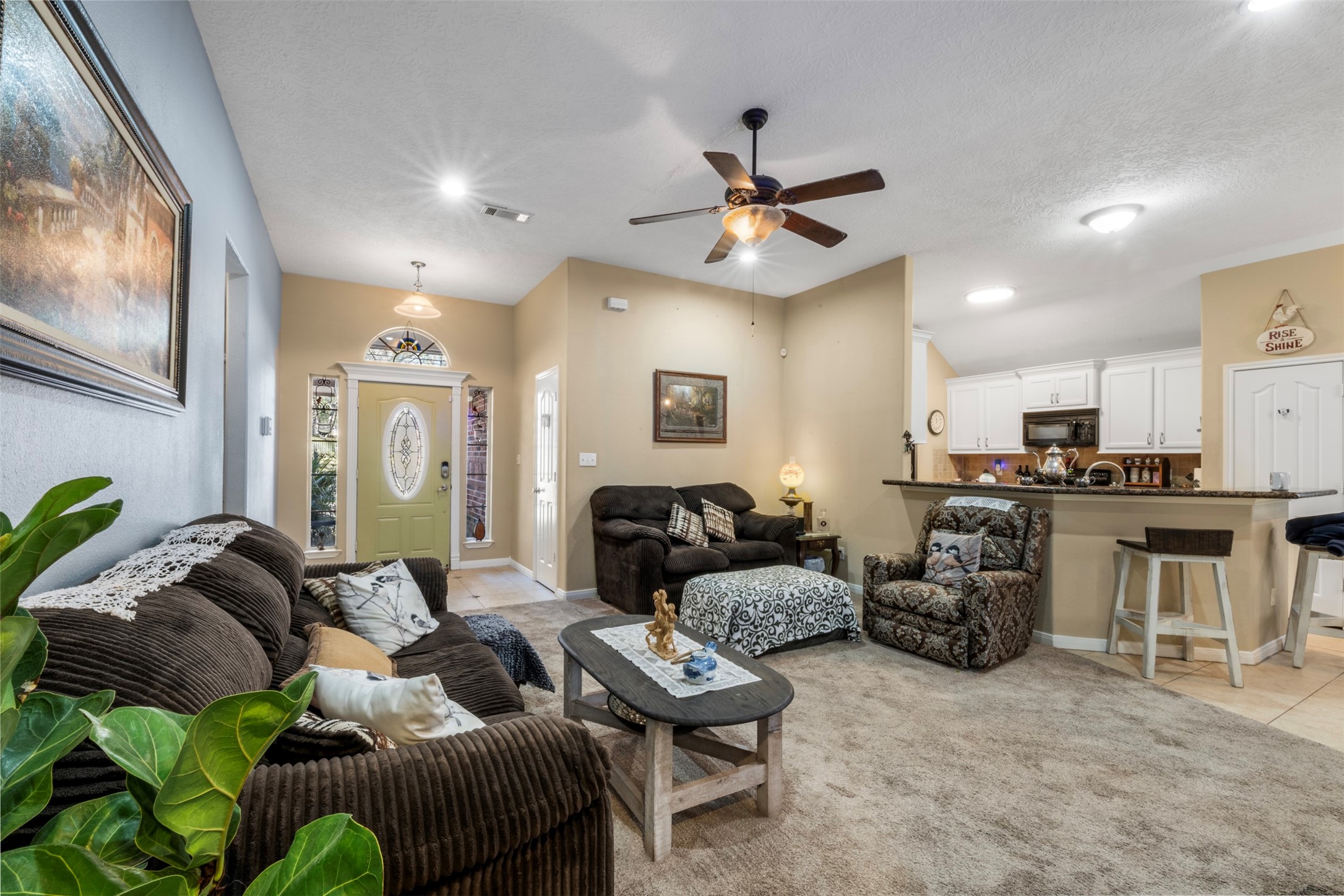 411 Shawnee Conroe, TX 77316 - Photo 4 of 30 a living room with furniture kitchen view and a chandelier