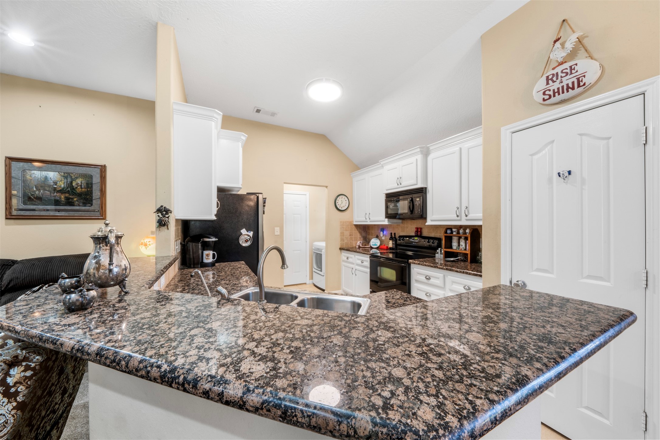 411 Shawnee Conroe, TX 77316 - Photo 9 of 30 a kitchen with large counter top space appliances and cabinets