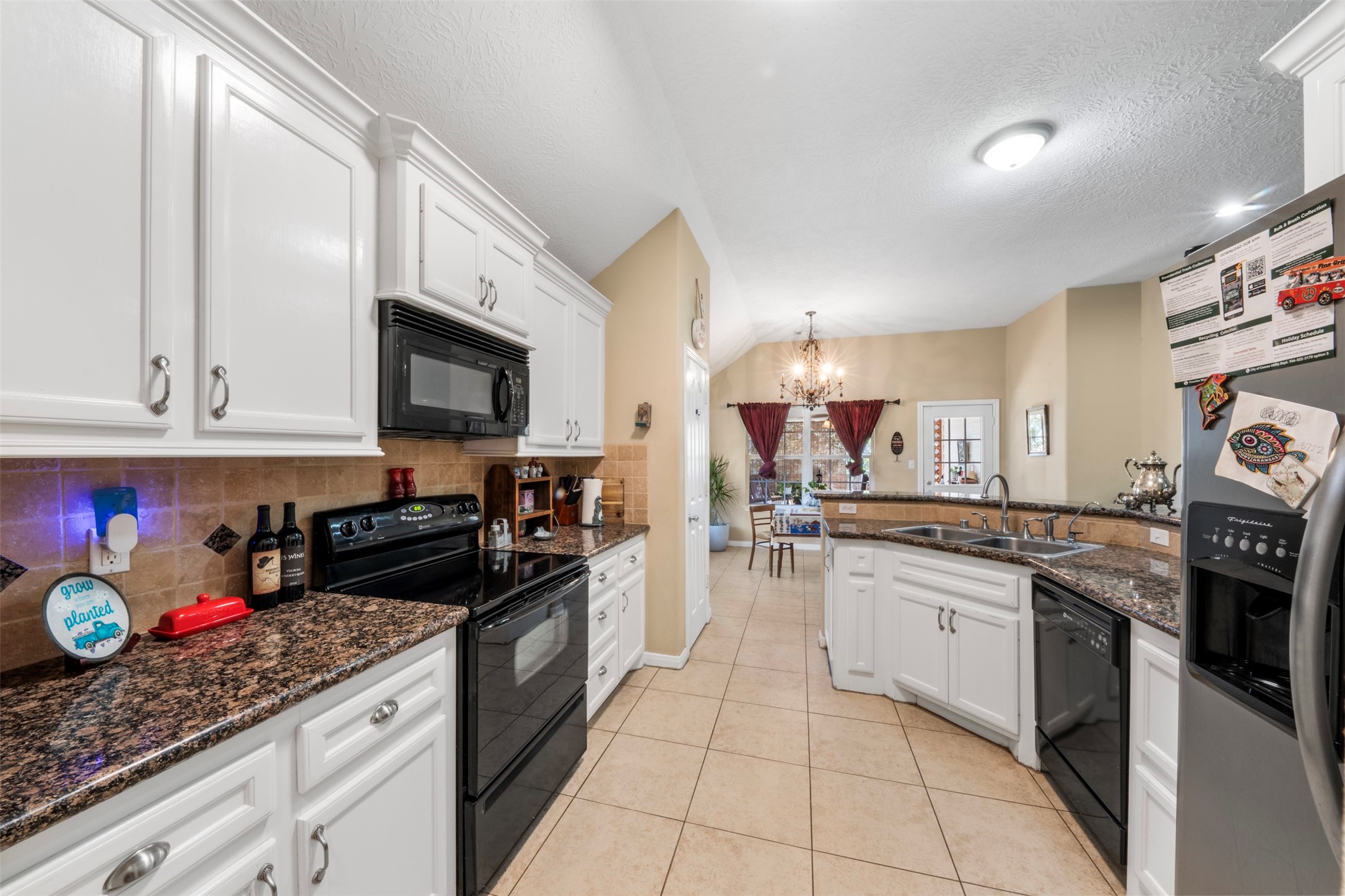 411 Shawnee Conroe, TX 77316 - Photo 10 of 30 a kitchen with stainless steel appliances granite countertop a stove a sink and a microwave