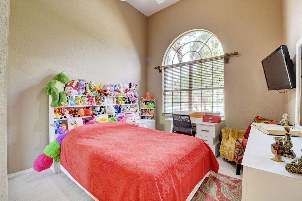 12320 Melrose Way Boca Raton, FL 33428 - Photo 16 of 34 a bedroom with a bed and a window