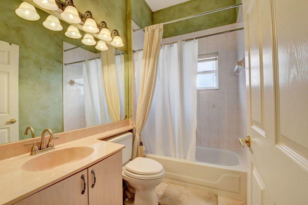 12320 Melrose Way Boca Raton, FL 33428 - Photo 17 of 34 a bathroom with a sink toilet and shower