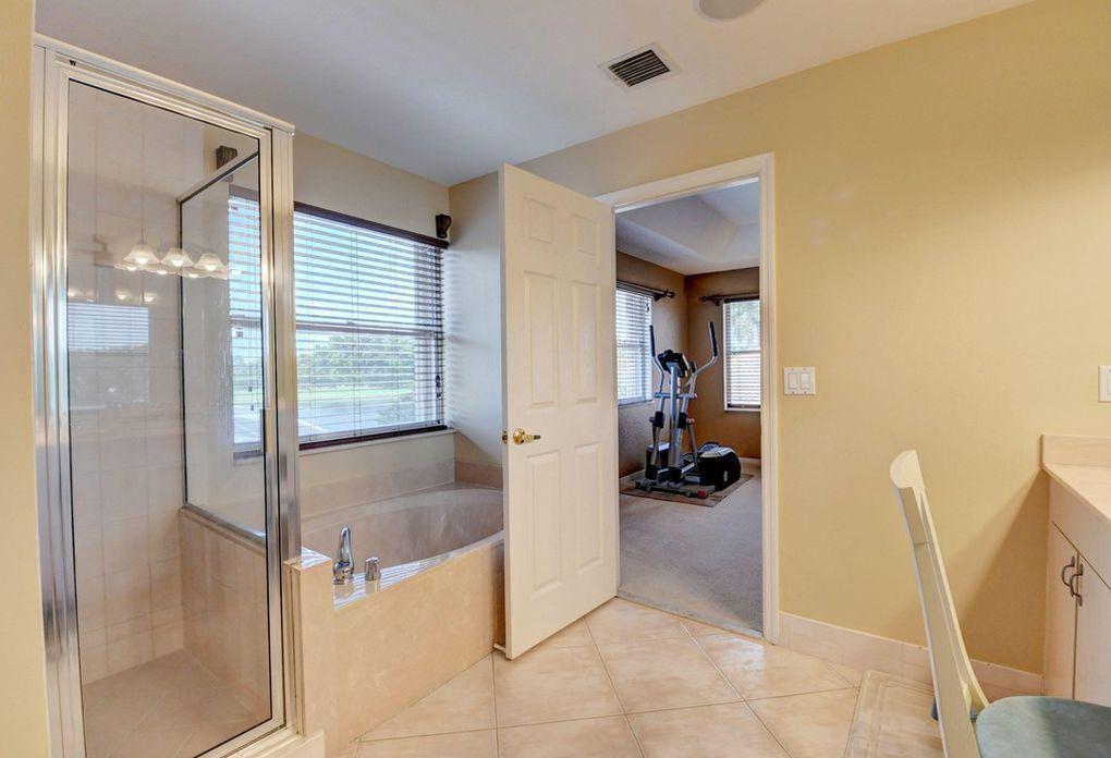12320 Melrose Way Boca Raton, FL 33428 - Photo 21 of 34 a en suite bathroom with a tub and mirror