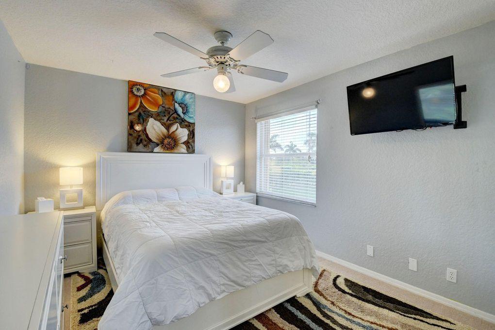 12320 Melrose Way Boca Raton, FL 33428 - Photo 23 of 34 a bedroom with a bed and a flat screen tv