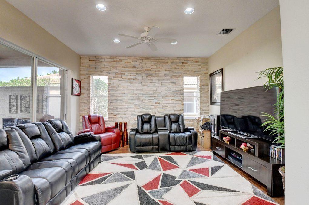 12320 Melrose Way Boca Raton, FL 33428 - Photo 8 of 34 a living room with furniture a fireplace and a flat screen tv