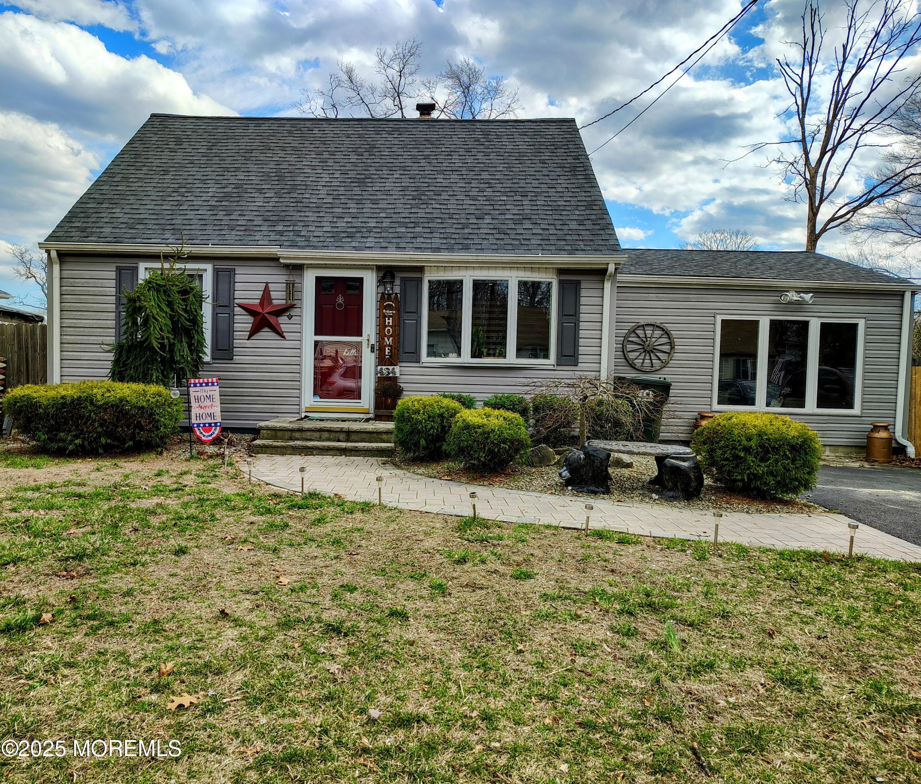 a front view of a house with sitting area and garden